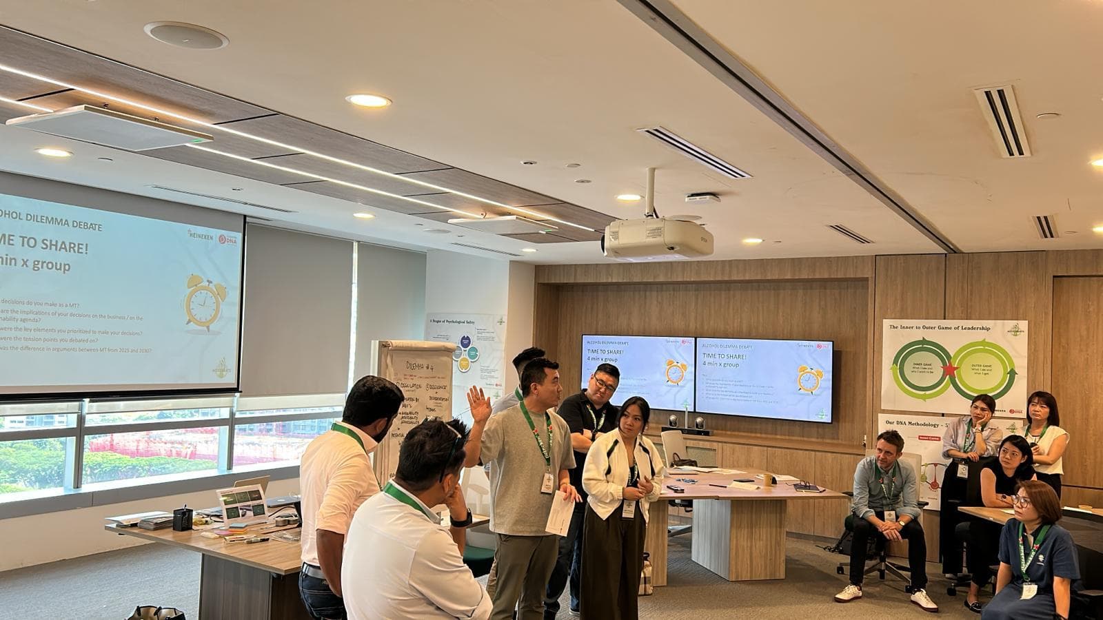 Leaders presenting their group's conclusions during a leadership dilemma debate in a CorporateDNA workshop